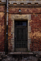 Fototapeta na wymiar Wooden doors of old, abandoned power plant in Riga, Andrejsala.