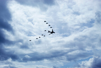 Military airplanes flying in V formation with blue sky and cloudy day at background. Military and aircraft concept