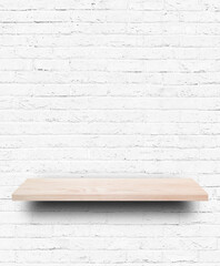 Empty wooden shelf on white brick wall background.
