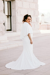 Young Polynesian bride standing in her wedding dress