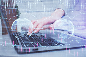 Multi exposure of woman hands typing on computer and forex chart hologram drawing. Stock market...