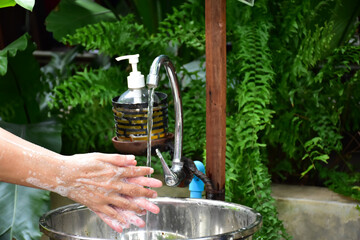 Hand washing with sanitizer to protect germs.