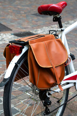 Fototapeta na wymiar White bike with brown leather saddlebag