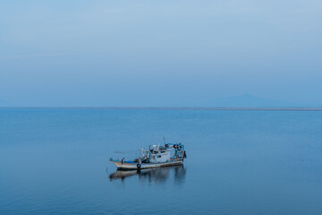 Obraz premium Fishing boat at anchor in ocean.