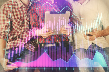 Double exposure of forex graph drawing and man and woman working together holding and using a mobile device. Trade concept.