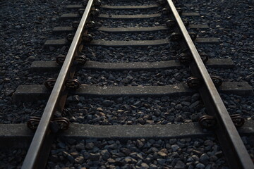 Close up and selective focus photo of railway track or railroad with morning sunlight.