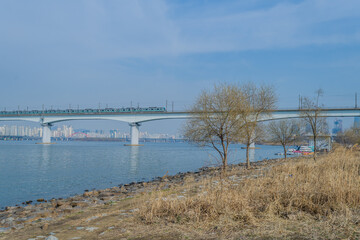 Subway train crossing bridge over river