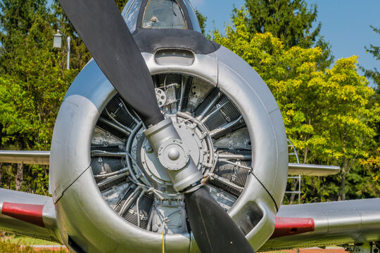 Closeup of engine and front cowling of T28 Trojan military training aircraft on display in public park.