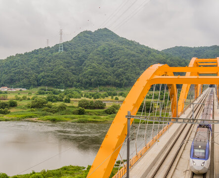 Top view of train crossing yellow bridge