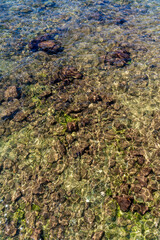 Aerial top view of sea waves hitting rocks on the beach in Salvador, Bahia, Brazil