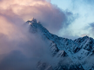 Clouds over snowy peak, New Zealand