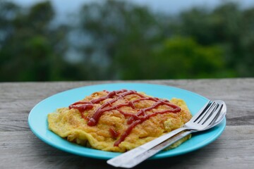 Fresh omelet with ketchup on rice The popular food of the  countryside viewpoint 