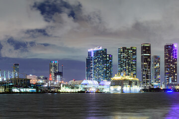 Miami skyline. Cruise ship in the Port of Miami at sunset with multiple luxury yachts. Beautiful Miami Florida skyline at sunset.