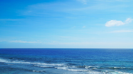 Naklejka na ściany i meble Horizon seascape with blue sky, waves on the water of a sandy beach