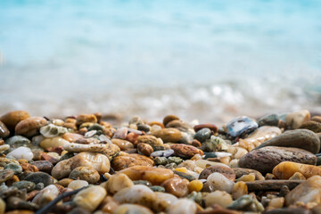 Selective focus on rocks texture with blur beach in background.