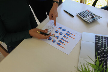 business team hands searching for data on mobile phone  with analyzing charts at his workplace.