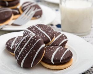 Chocolate cream filled cookies with milk