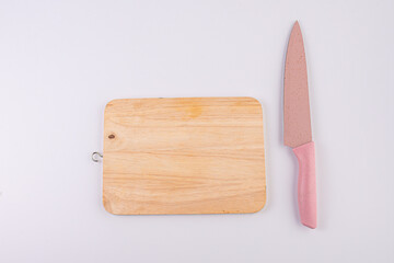 Wooden cutting board and knife isolated on white background. 