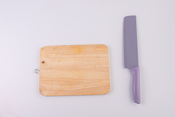 Wooden cutting board and knife isolated on white background. 
