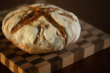 Sour dough bread on a checkerboard cutting board landscape