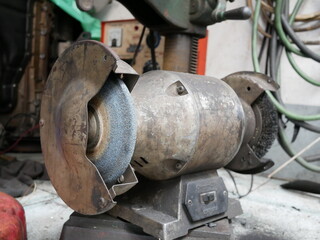 electric bench grinder in a garage.