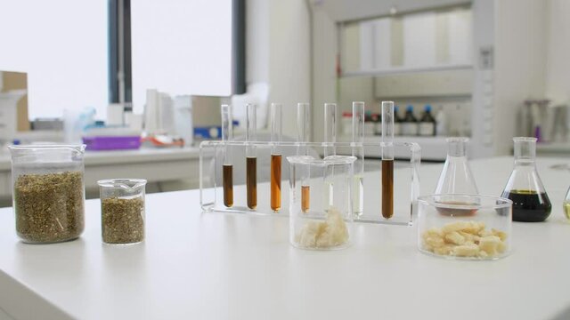 CBD oil, hemp seeds and terpenes in glass on laboratory desk