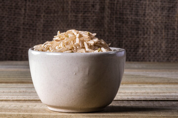 integral rice on glass bowl isolated on wooden table in Brazil