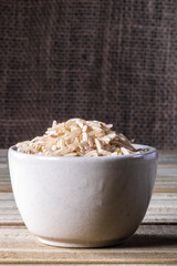 integral rice on glass bowl isolated on wooden table in Brazil
