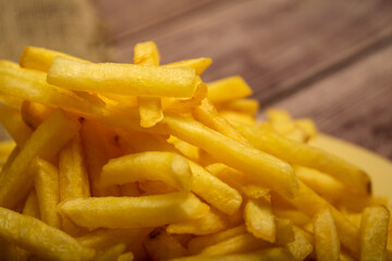 French fries on a homespun fabric with a rough texture. Close up.