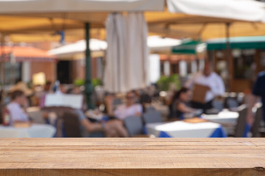 Empty table with Blurred abstract background of outdoor cafe in Milan, Italy.