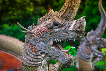 The background of the Wat Pa Kham Charoen is a beautiful old church with a Buddhist statue and a tree-lined temple, with tourists and travelers always making merit in Udon Thani, Thailand.