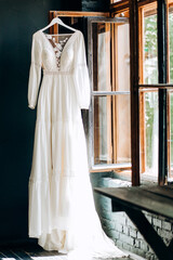 Obraz na płótnie Canvas Wedding concept - wedding dress and wedding accessorie in hotel room on the window