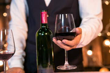 Waitress man pouring wine into glass