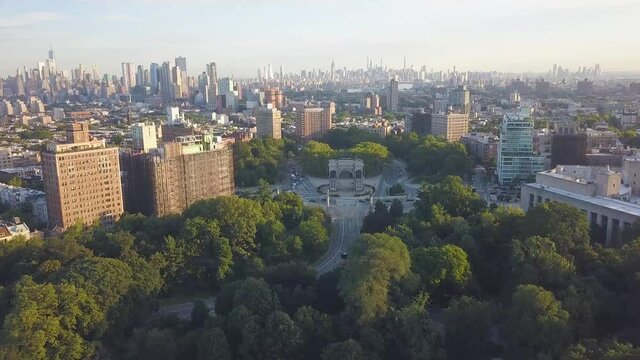 Aerial view of Grand Army Plaza in Brooklyn on a sunny summer morning with Manhattan and New York skyline in the background