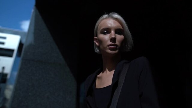 young masculine woman alone outdoors, portrait of transsexual or transgender persone