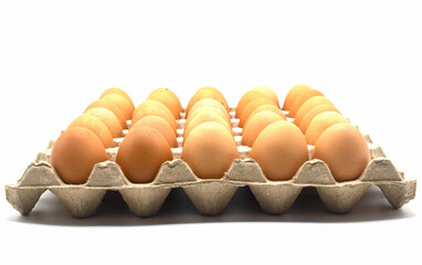 close-up raw fresh chicken eggs in cardboard box