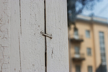 Old wooden window frame with cracked white paint.