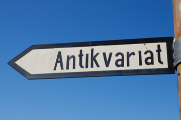 Swedish signpost with direction to a antiquarian.