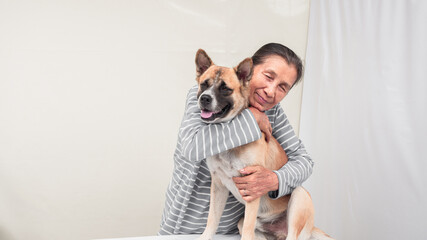 senior hugging dog in smiling face, white background copy space