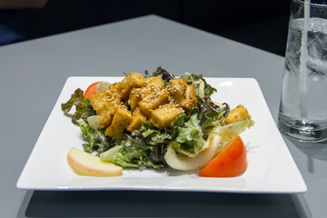 Tofu salad on a white plate