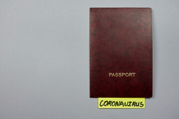 A passport and sticker with word - Coronavirus. Effect of COVID-19 on international business and travel industry. Flights cancellations due to pandemic