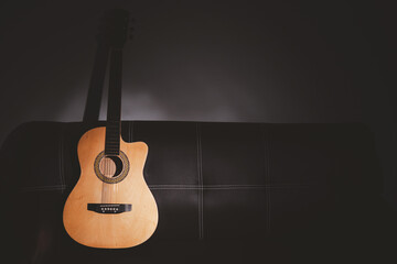 Fototapeta na wymiar brown acoustic guitar on sofa