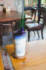 Butterfly pea juice and milk in a glass