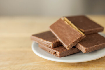 Wafers and chocolate deep, Junk Foods on wooden background.