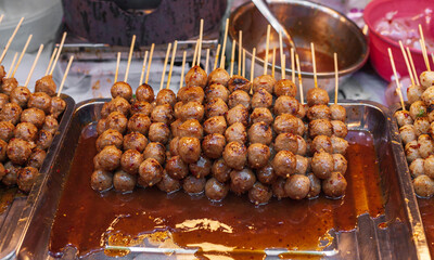 Meatballs topped with sauce, Junk food from Thailand.