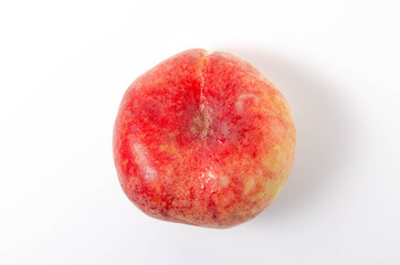One bright, juicy peach on a white background. Fig peach in close-up on a white background one on one. Water drops on a peach, dew in close-up