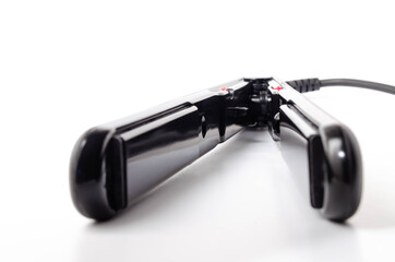 Iron, hair straightener. Align hair, curls, hairstyle. Leveler on a white background in close-up,...