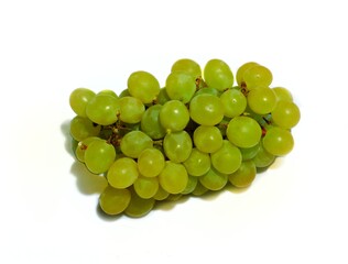 A bunch of green raisins raisins on a white background