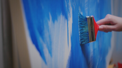 Woman with painting skill in studio.