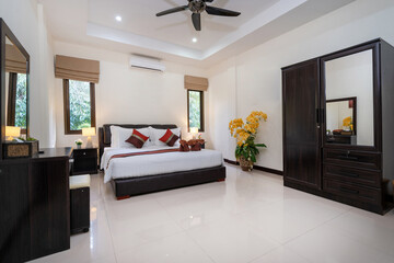 Interior design of house, home, condo and villa feature double bed, red bed runner, and dressing table in bedroom